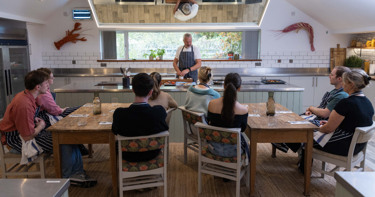 Nick Nairn teaching a small group in the Cook School demo kitchen at Lake of Menteith.