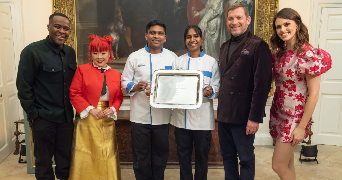 Ashish and Loki holding their Bake Off: The Professionals trophy, alongside presenters Liam Charles, Ellie Taylor and judges Benoit Blin and Cherish Finden