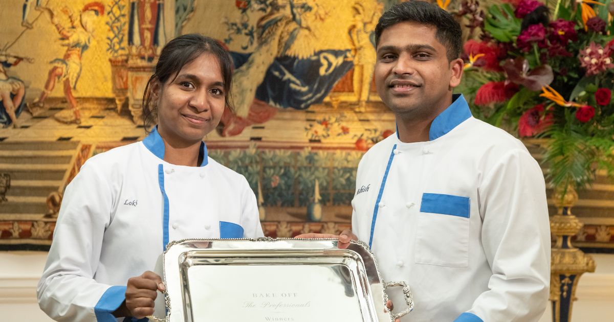 Ashish and Loki holding their Bake Off: The Professionals winner trophy