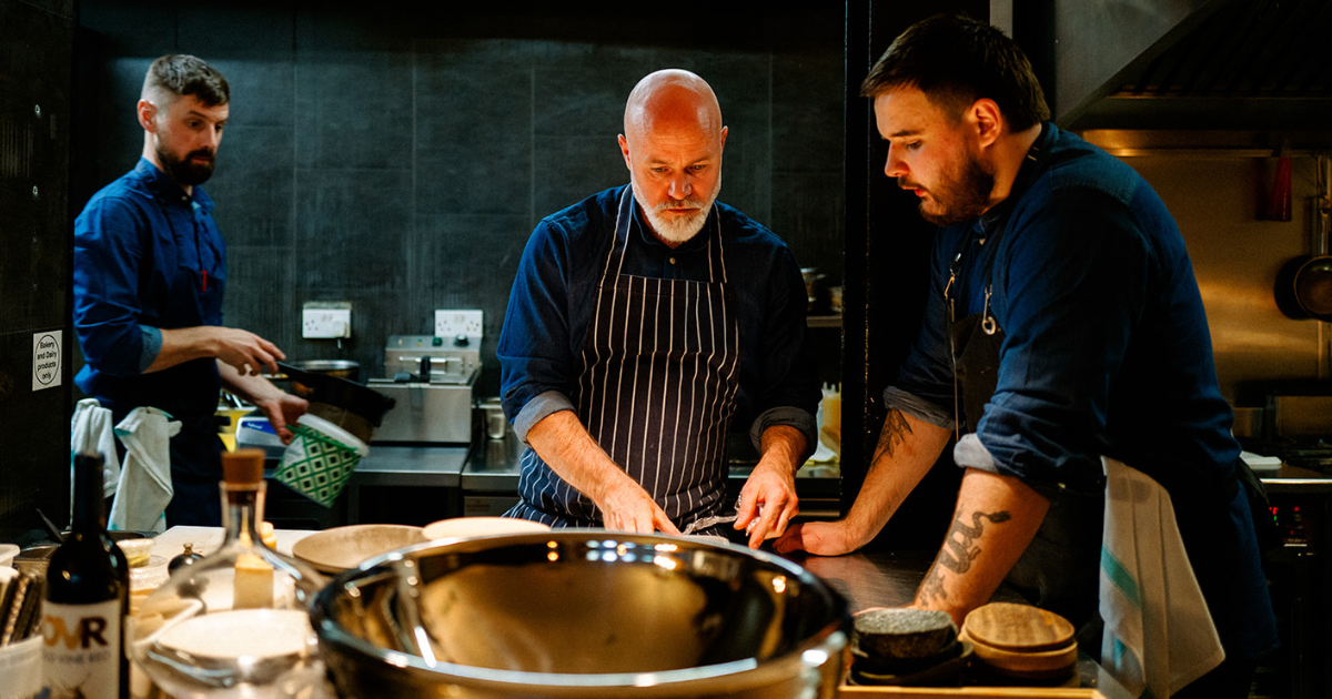 John Wyer with chefs in the kitchen at Forest Avenue