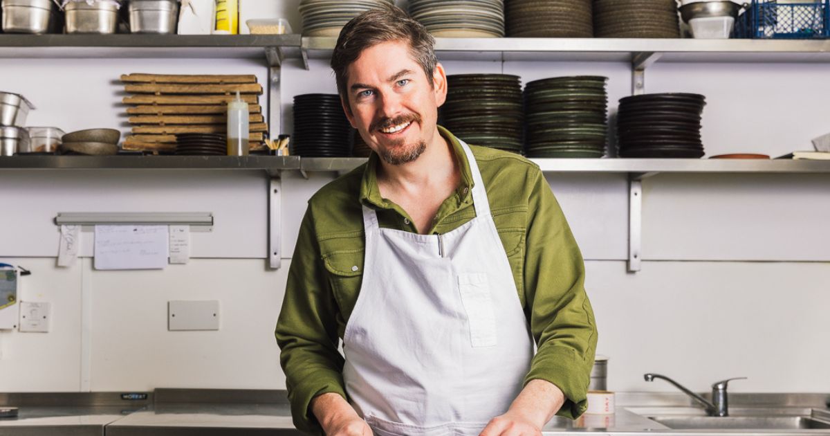 Peter McKenna smiling in the kitchen