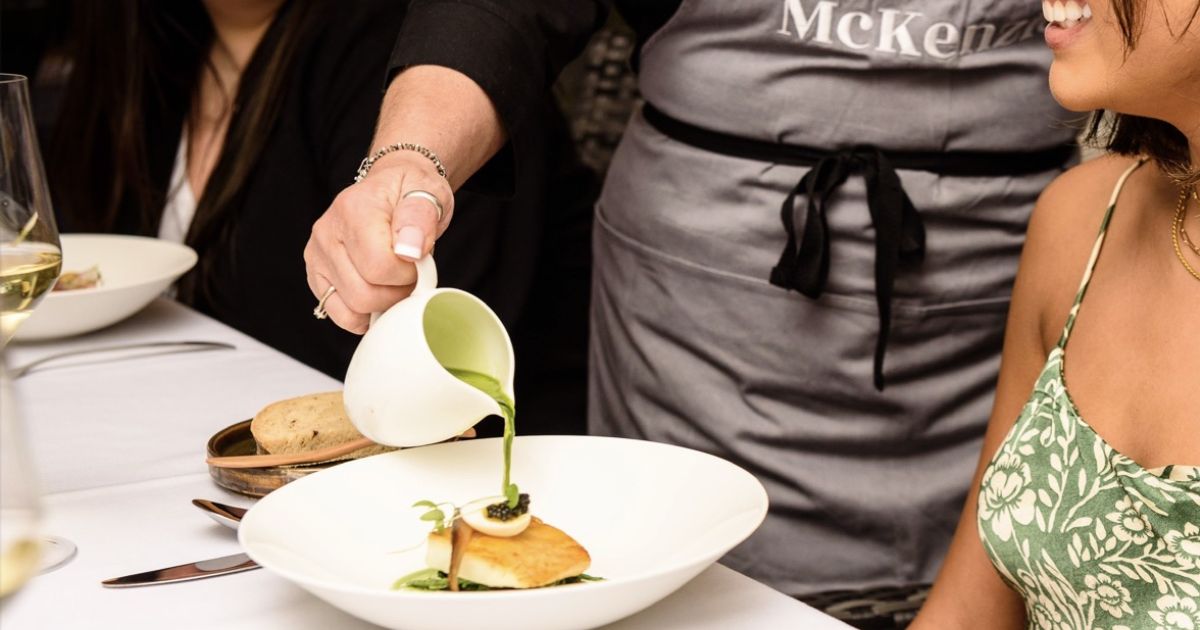 Simon Mckenzie pouring a sauce