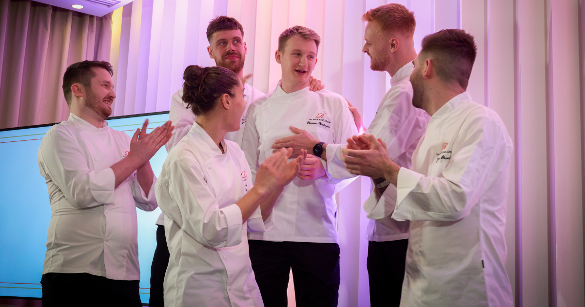 Harrison Brockington reacts after being announced as The Roux Scholarship winner, surrounded by his fellow competitors